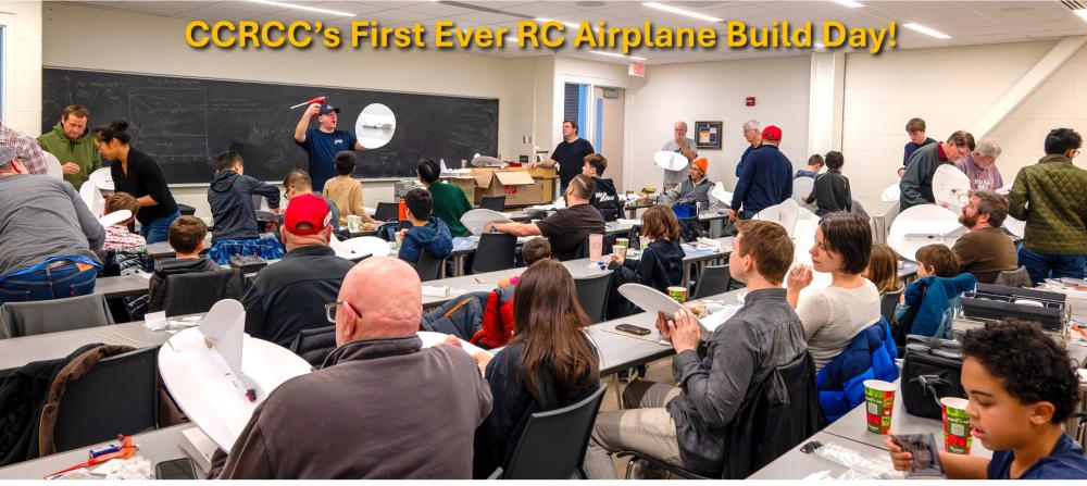 Classroom workshop with people building RC airplanes.