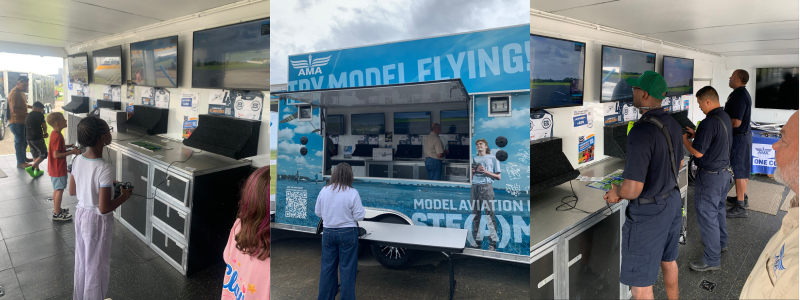 Mobile aviation exhibit with interactive screens and people observing displays.