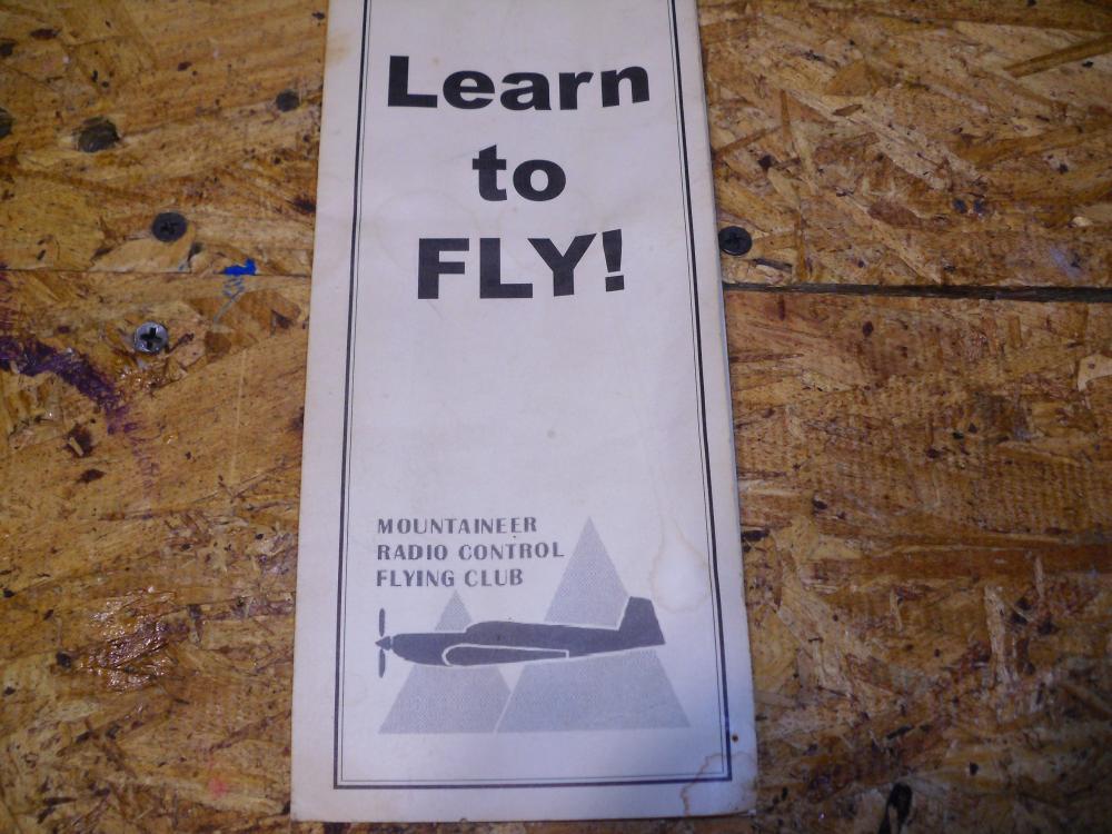 Brochure for flying lessons on a wooden surface.
