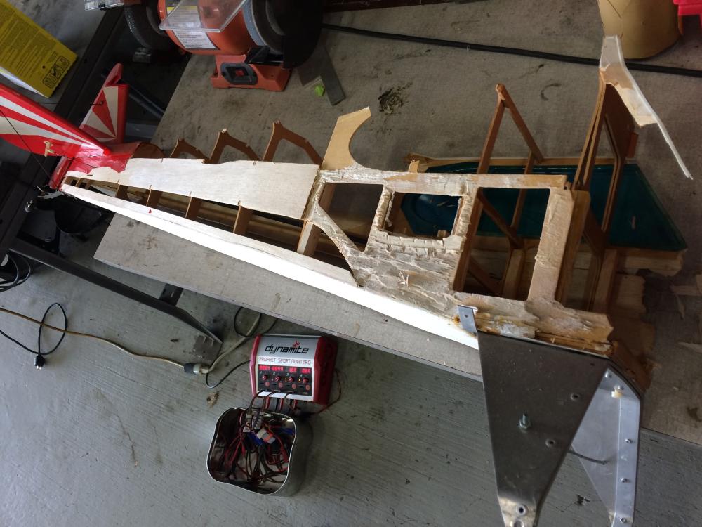 Model airplane under construction on a workshop floor.