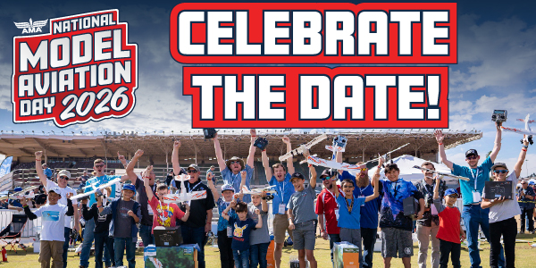 Crowd holding model airplanes, celebrating at an outdoor event under a partly cloudy sky.