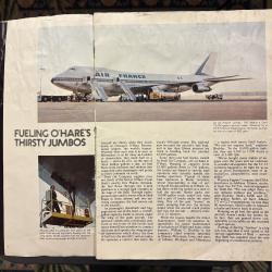 Airport scene with an Air France jumbo jet receiving fuel from a tanker truck.