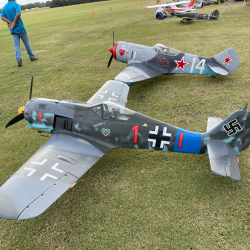 Two large model fighter planes on grass, World War II-era design, detailed markings.