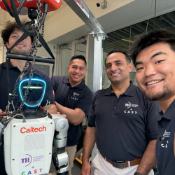 Four smiling people with a Caltech robot in a lab setting.