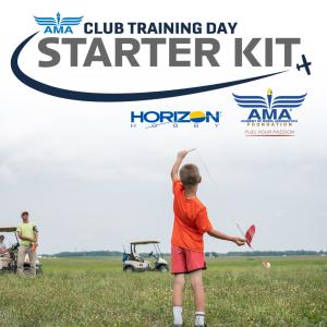 Boy holding model glider on a grassy field with people and golf carts in the background.