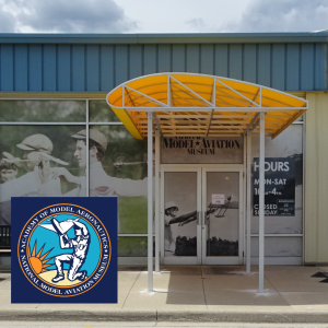 Exterior of a model aviation museum with a yellow canopy.