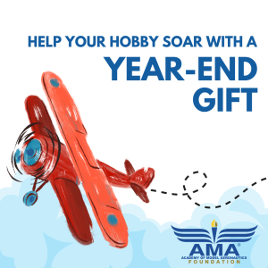 Red biplane flying among clouds, AMA Foundation logo in corner.