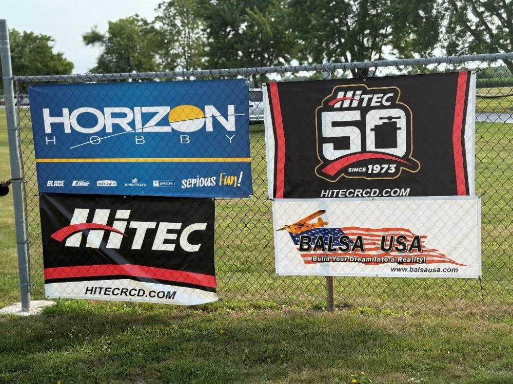 Banners on a fence promoting Horizon Hobby, HITEC, and BALSA USA.